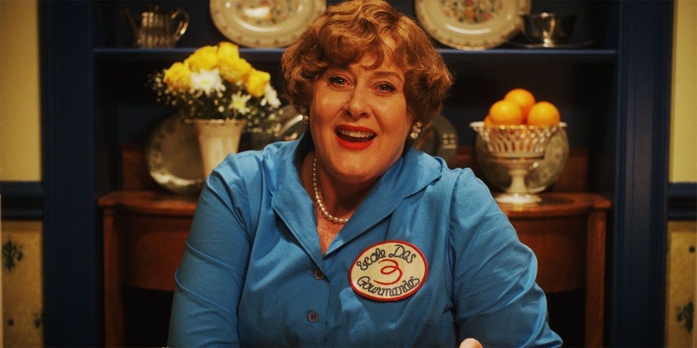 Julia Childs smiling while in a blue dress in Julia season 2