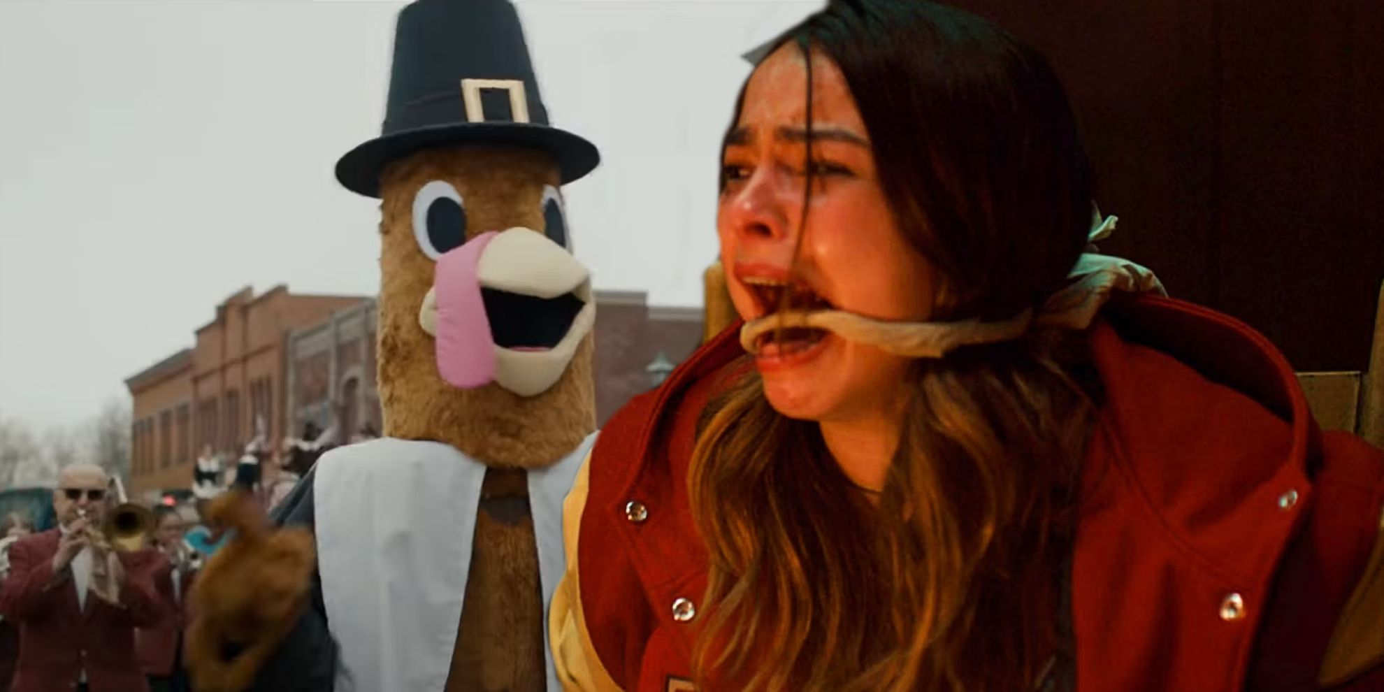 A turkey mascot at a Thanksgiving parade and Addison Rae as Gabby screaming while bound in Thanksgiving