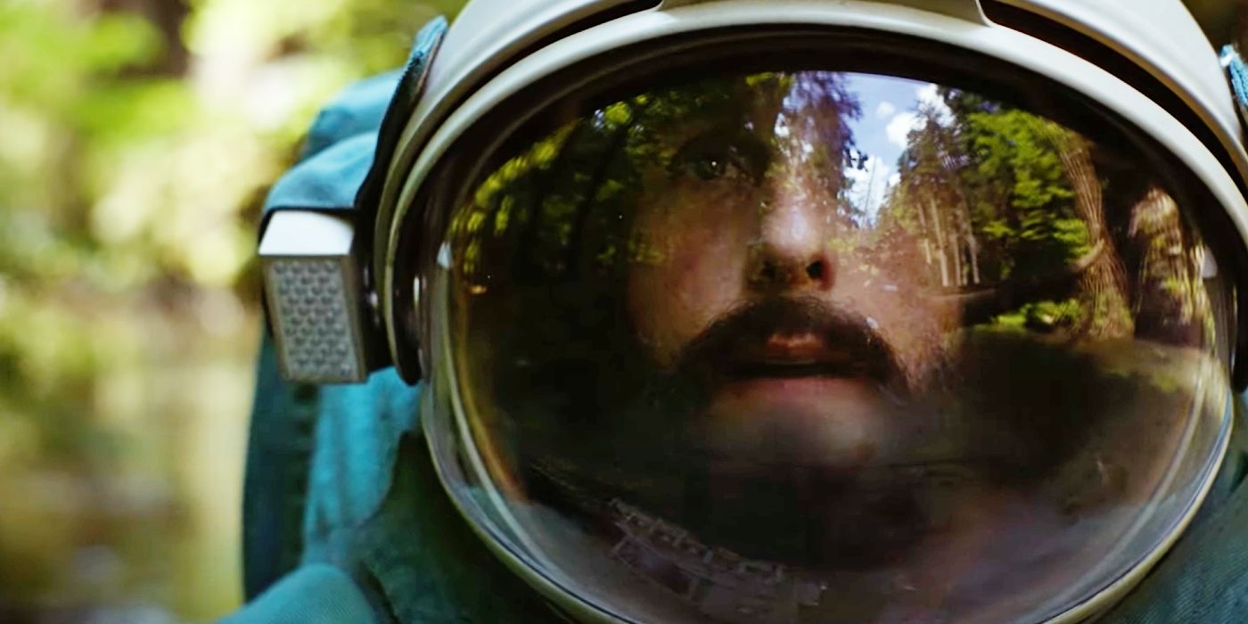 Adam Sandler wearing a space suit in a forest in Spaceman (2024).