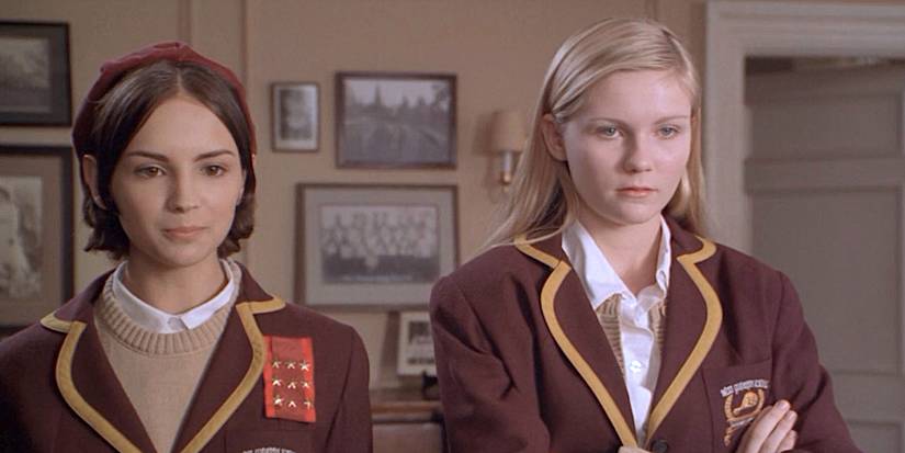 Rachel Leigh Cook's Abby and Kirsten Dunst's Verena stand in an office in school uniforms in All I Wanna Do