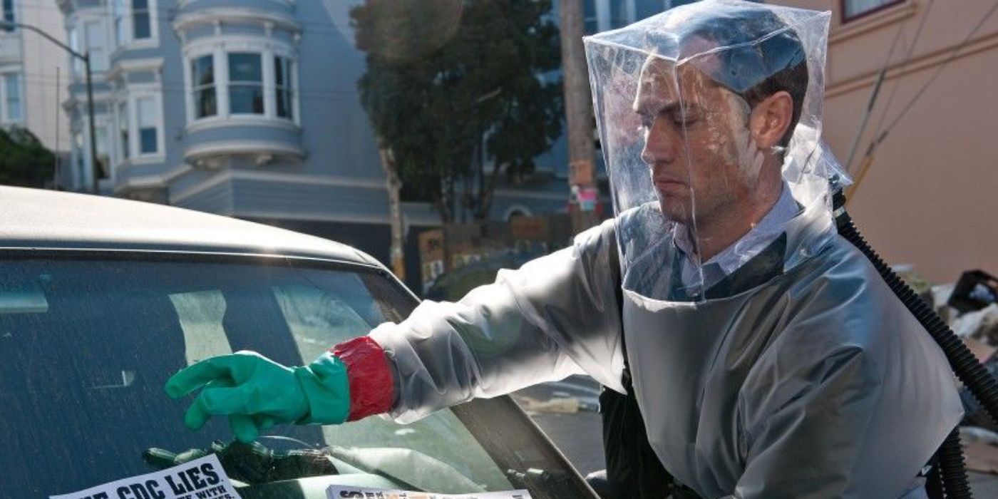 Allan from Contagion in a hazmat suit putting a flyer on a windshield