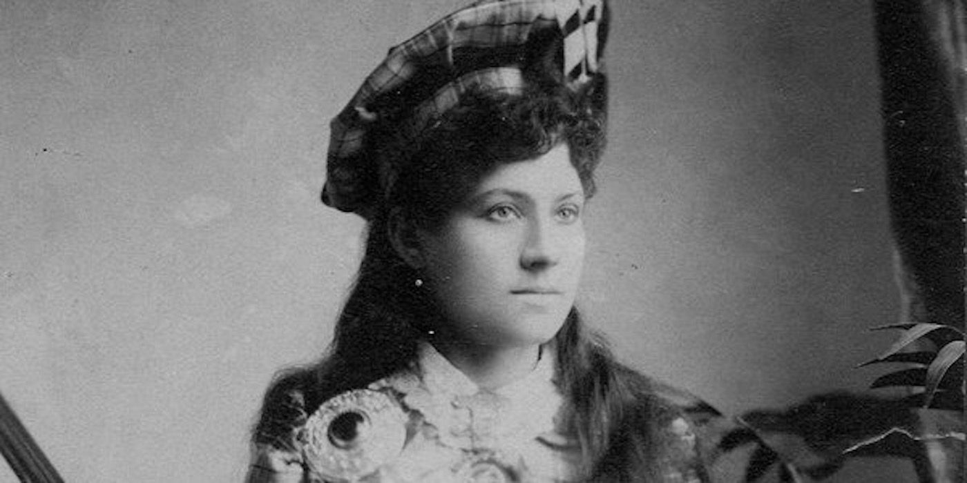 Annie Oakley dressed up, posing for photograph 