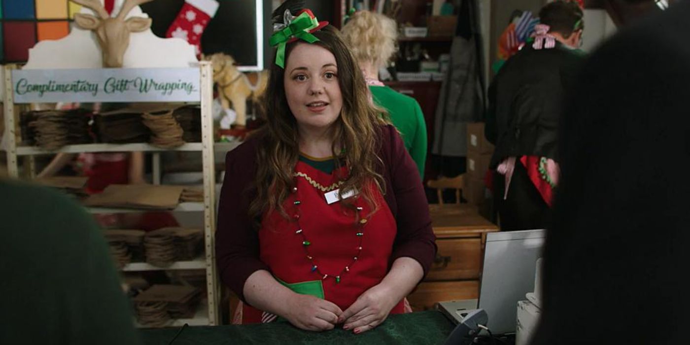 April Cameron as Patty dressed in a Christmas outfit working behind a stall in A Twist of Christmas.