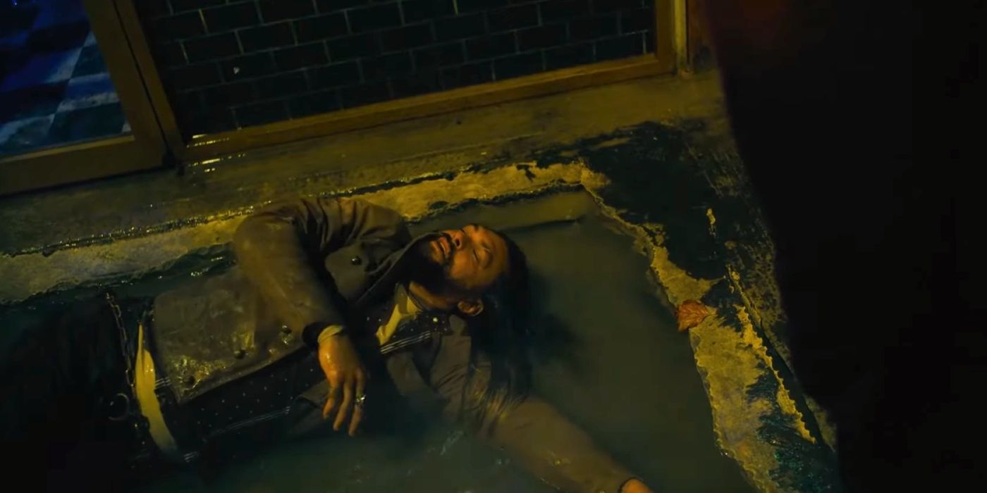 Arthur Curry (Jason Momoa) lies on his back in a puddle in The Flash