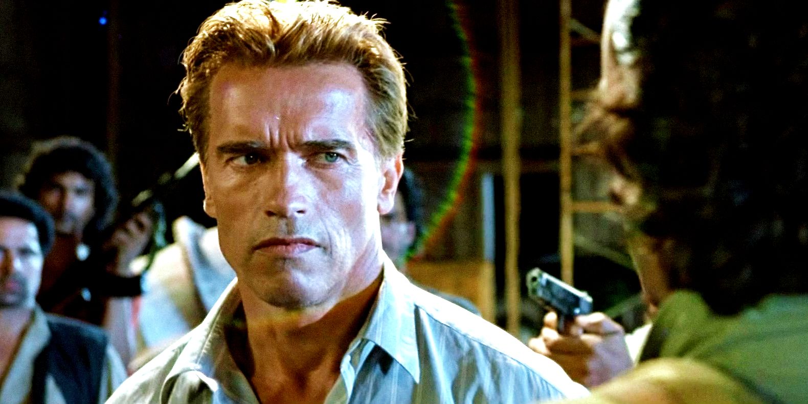Arnold Schwarzenegger as Harry Tasker with gun pointed at him in True Lies movie
