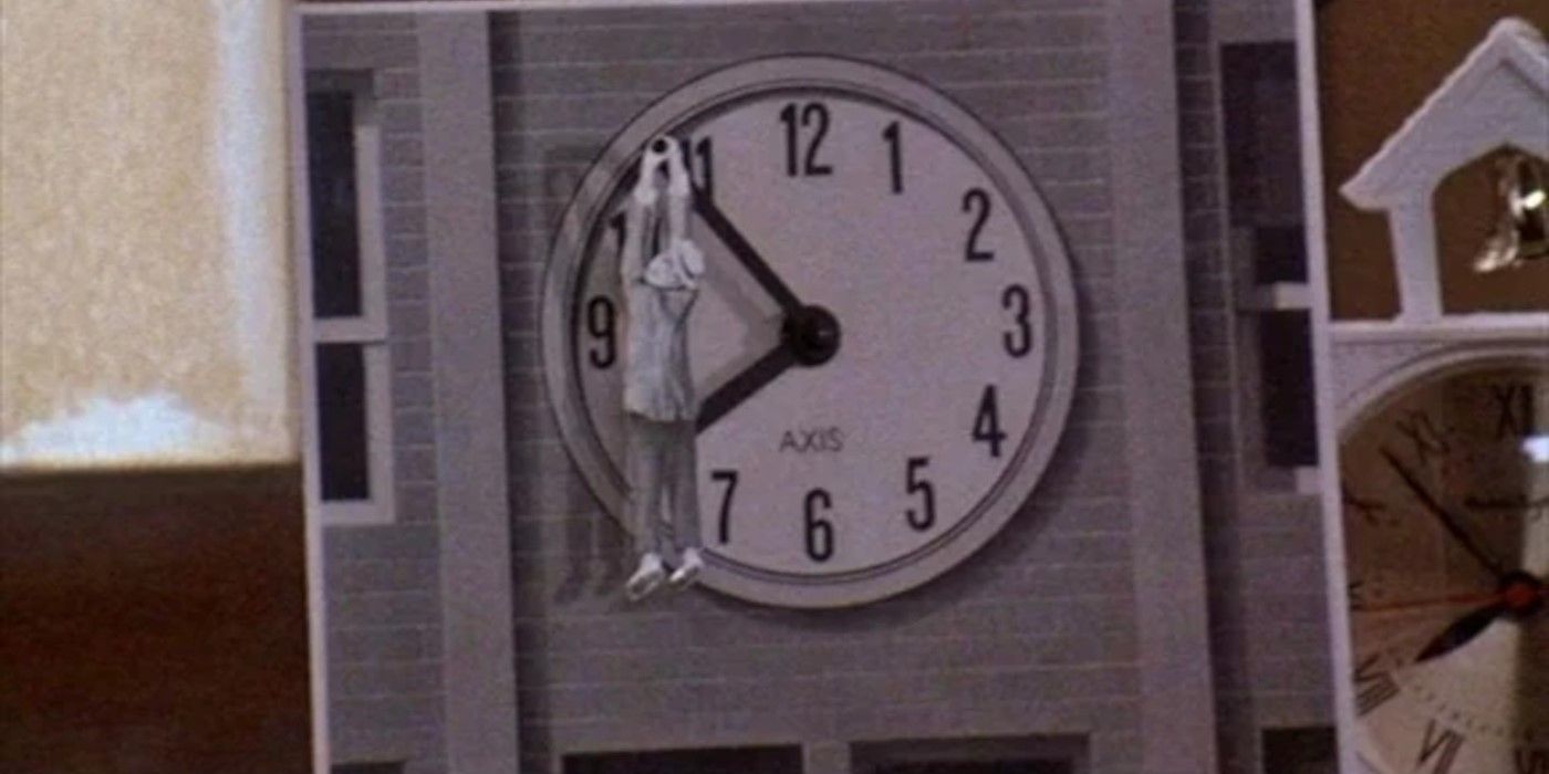 A clock with a man hanging off of it from the opening scene of Back to the Future