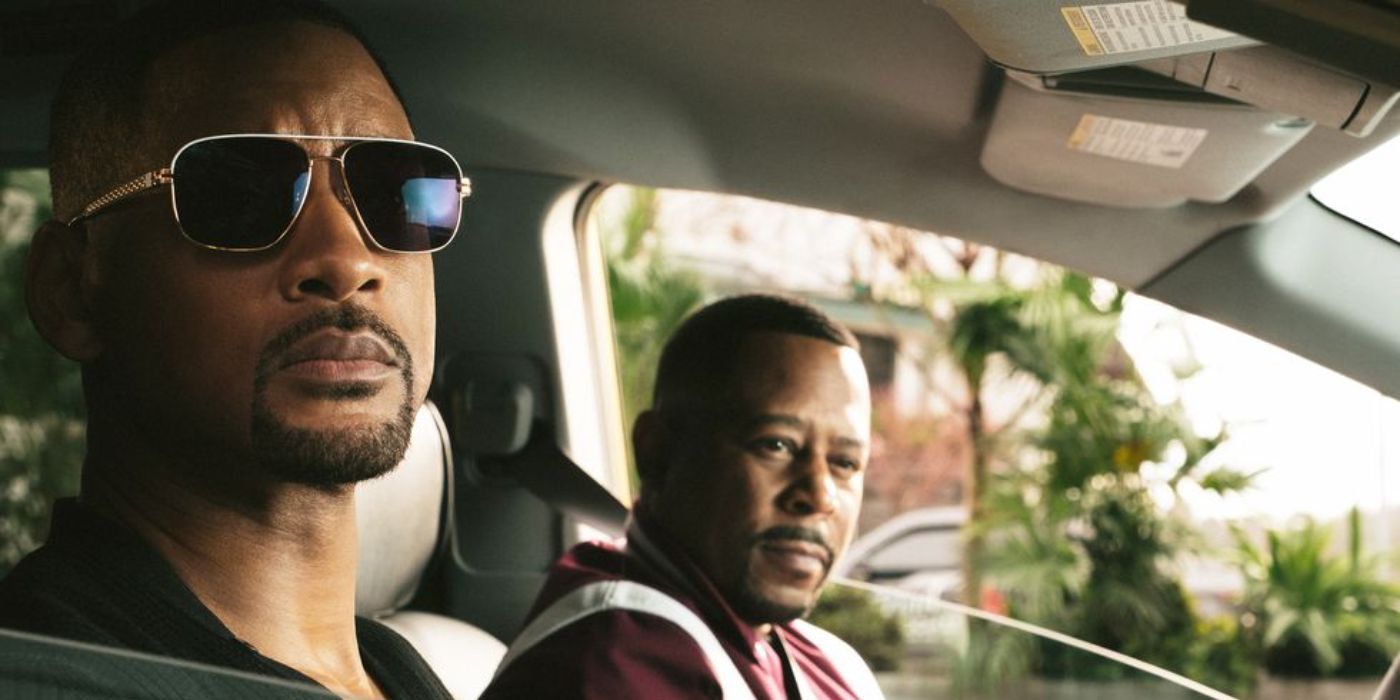 Will Smith and Martin Lawrence sitting in a car looking out the window as their characters from Bad Boys 