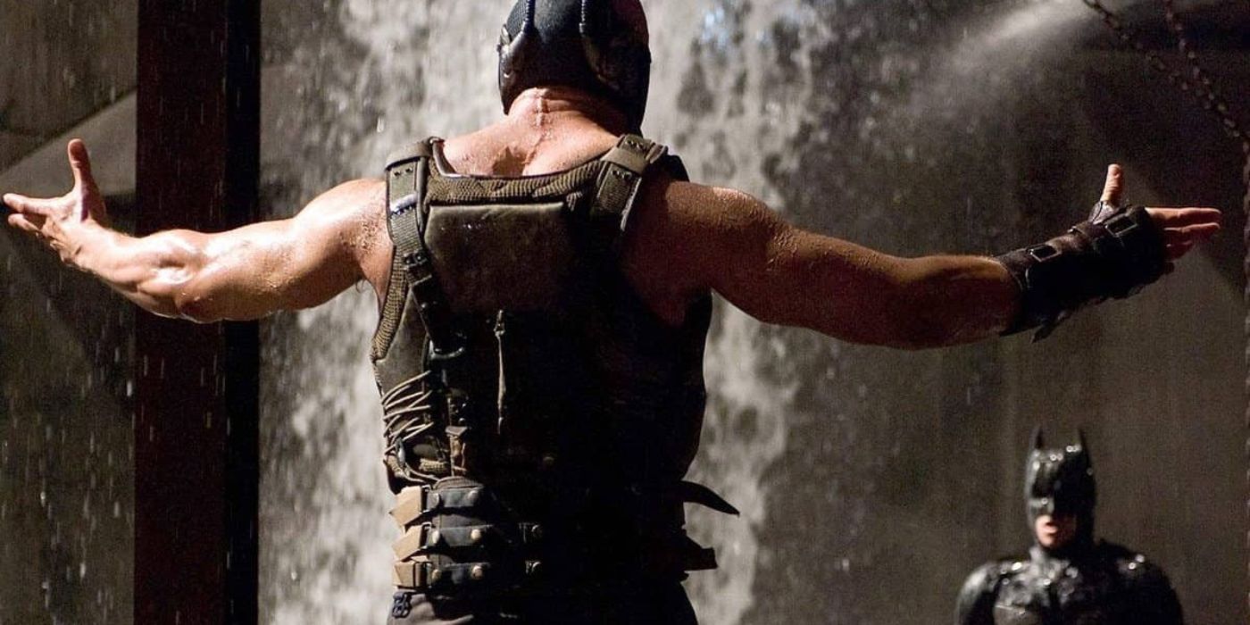 Bane approaching Batman with open arms in The Dark Knight Rises