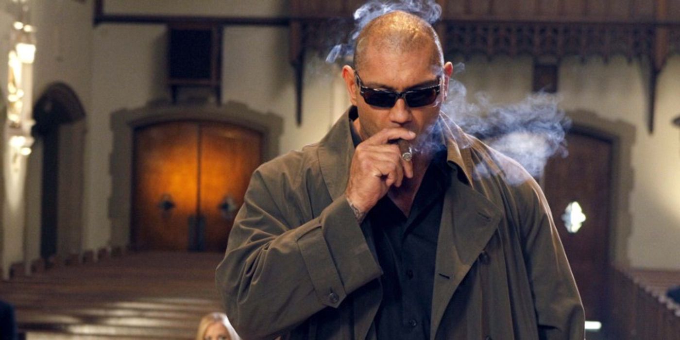 Dave Bautista smoking a cigar in a church in Chuck