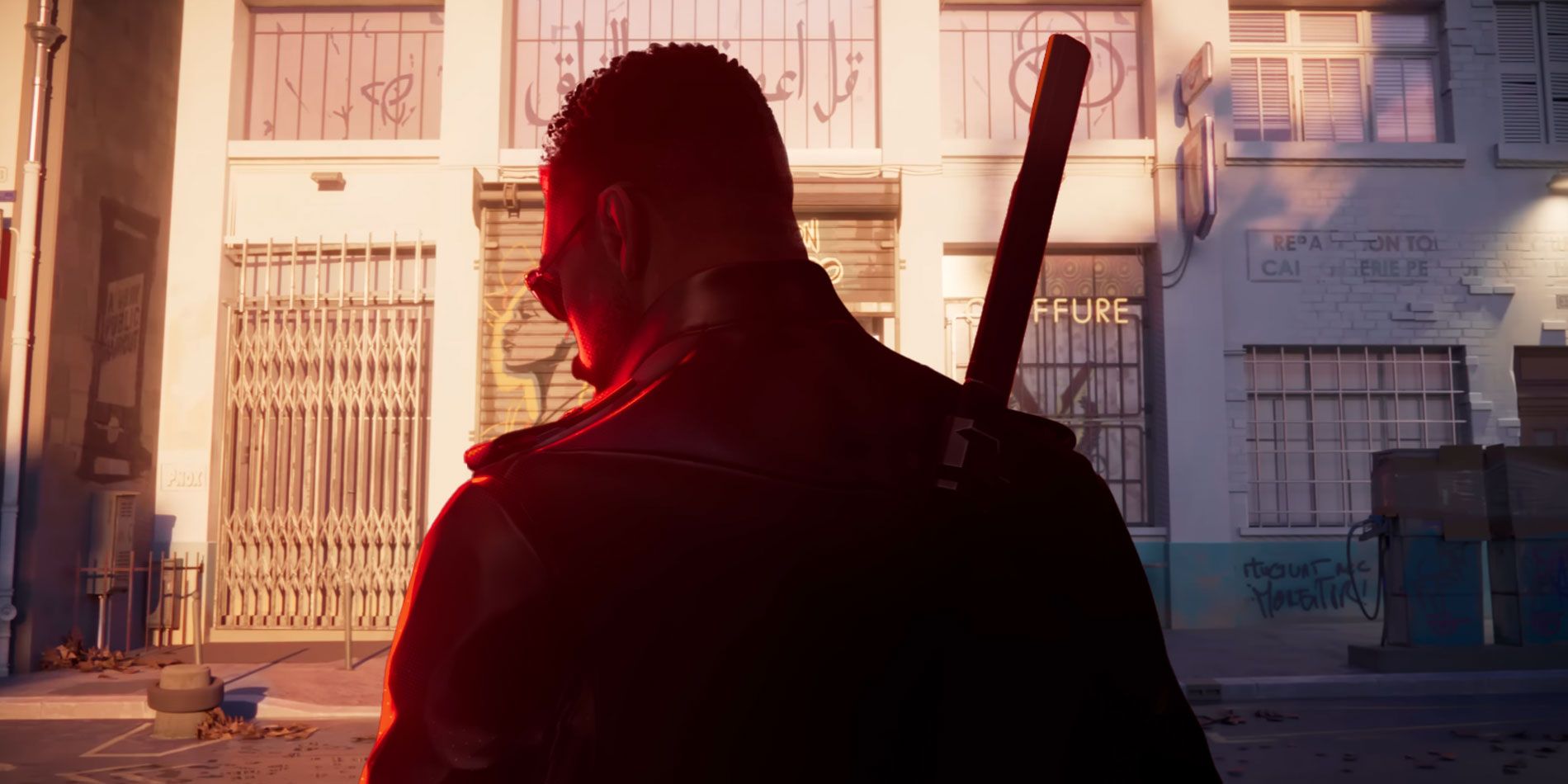Blade standing in front of a storefront salon in France.