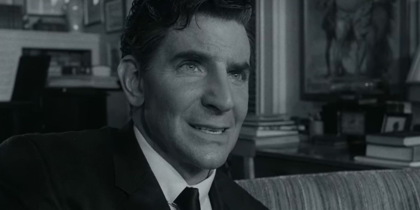 Bradley Cooper as Leonard Bernstein in black and white looking thoughtful in Maestro