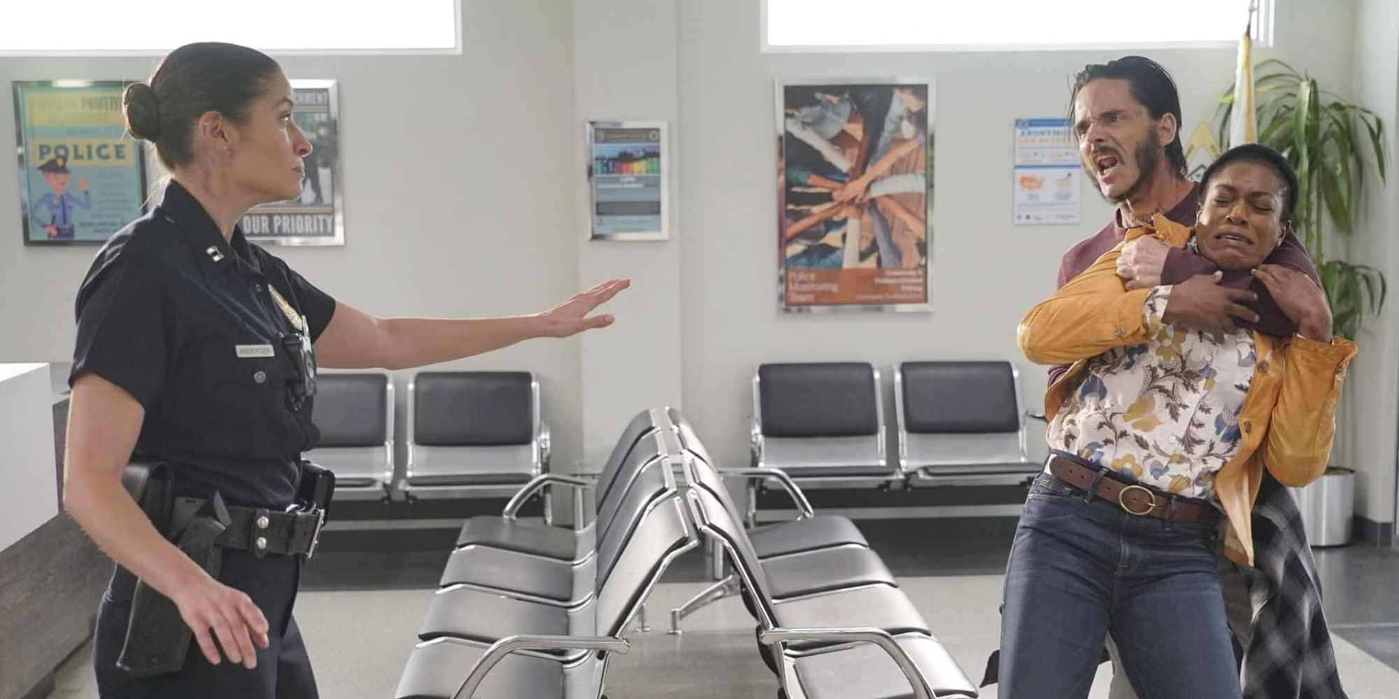 Captain Andersen (Mercedes Mason) in uniform holding her hand out to a man holding a woman against her will in The Rookie