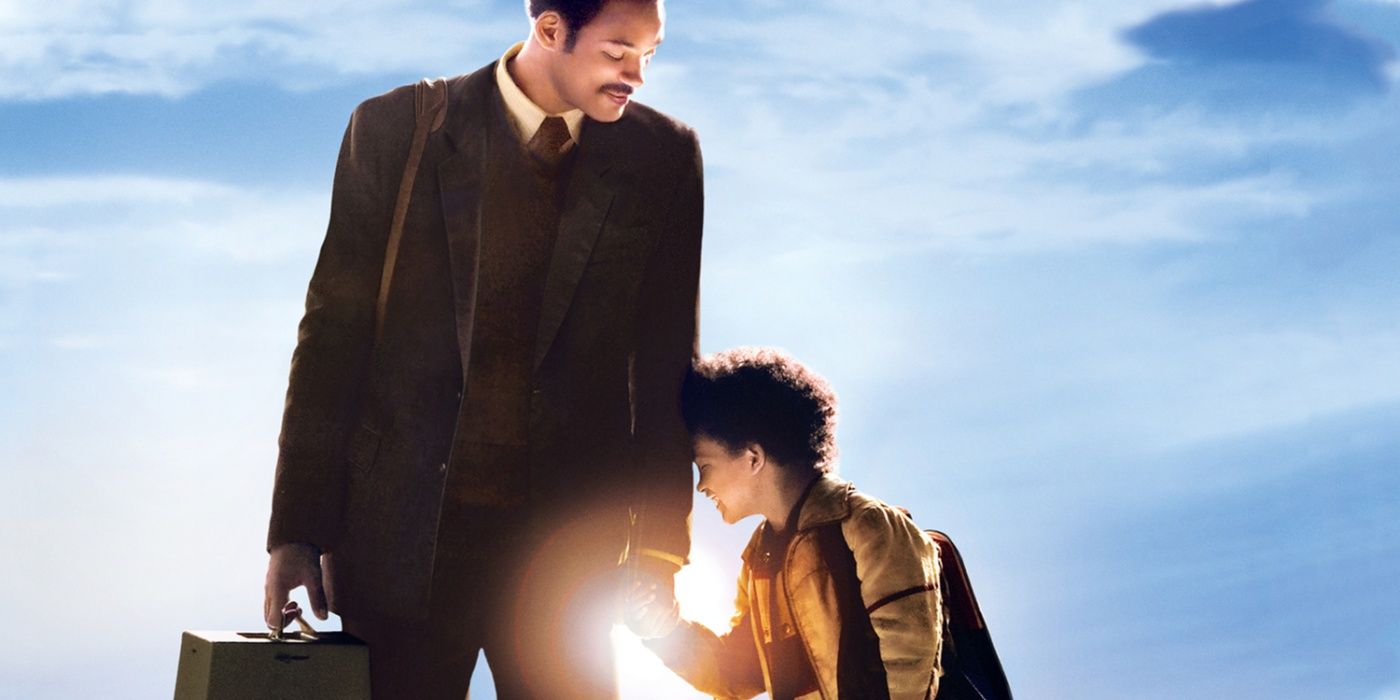 Chris Gardner (Will Smith) holding his son Chris' (Jaden Smith) hand as the sun glows behind them in The Pursuit of Happyness