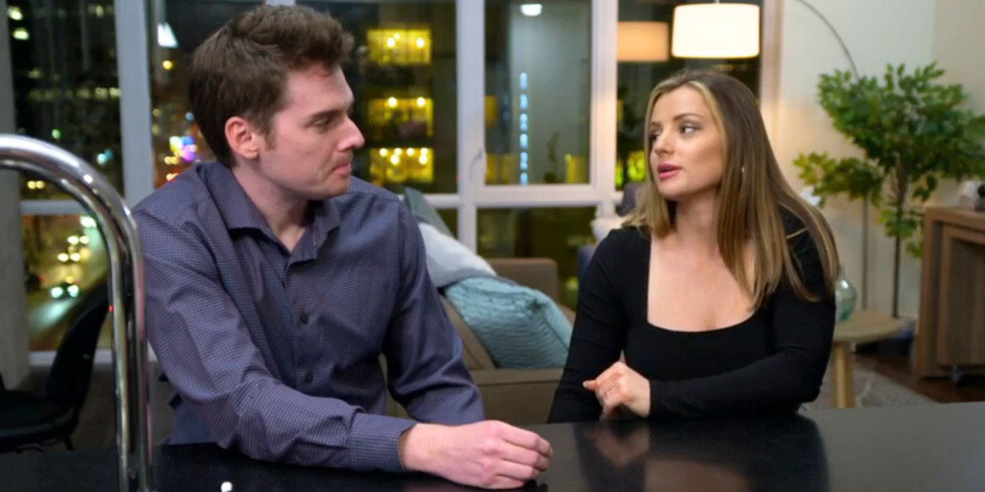 Clare Kerr and Cameron Frazer from Married at First Sight season 17 sitting at kitchen counter talking