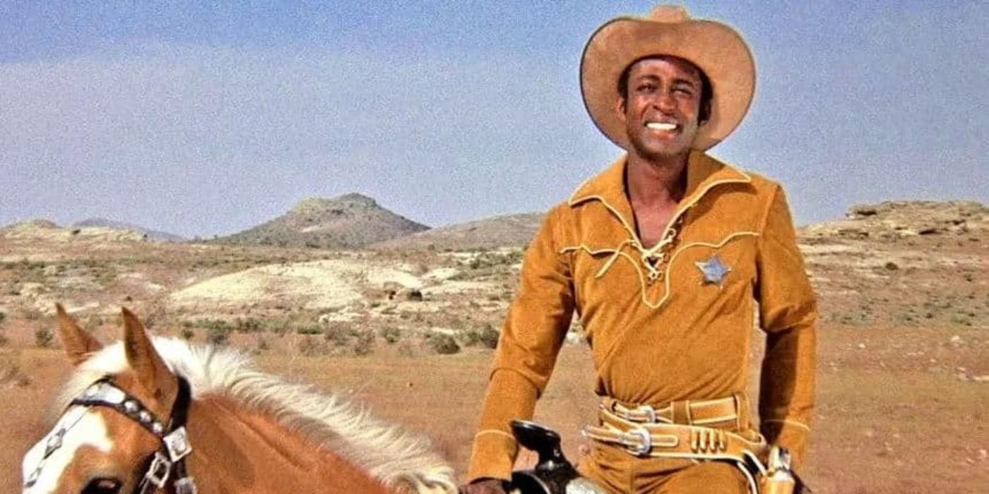 Cleavon Little as Sheriff Bart smiling and sitting atop a horse in a still from Blazing Saddles.