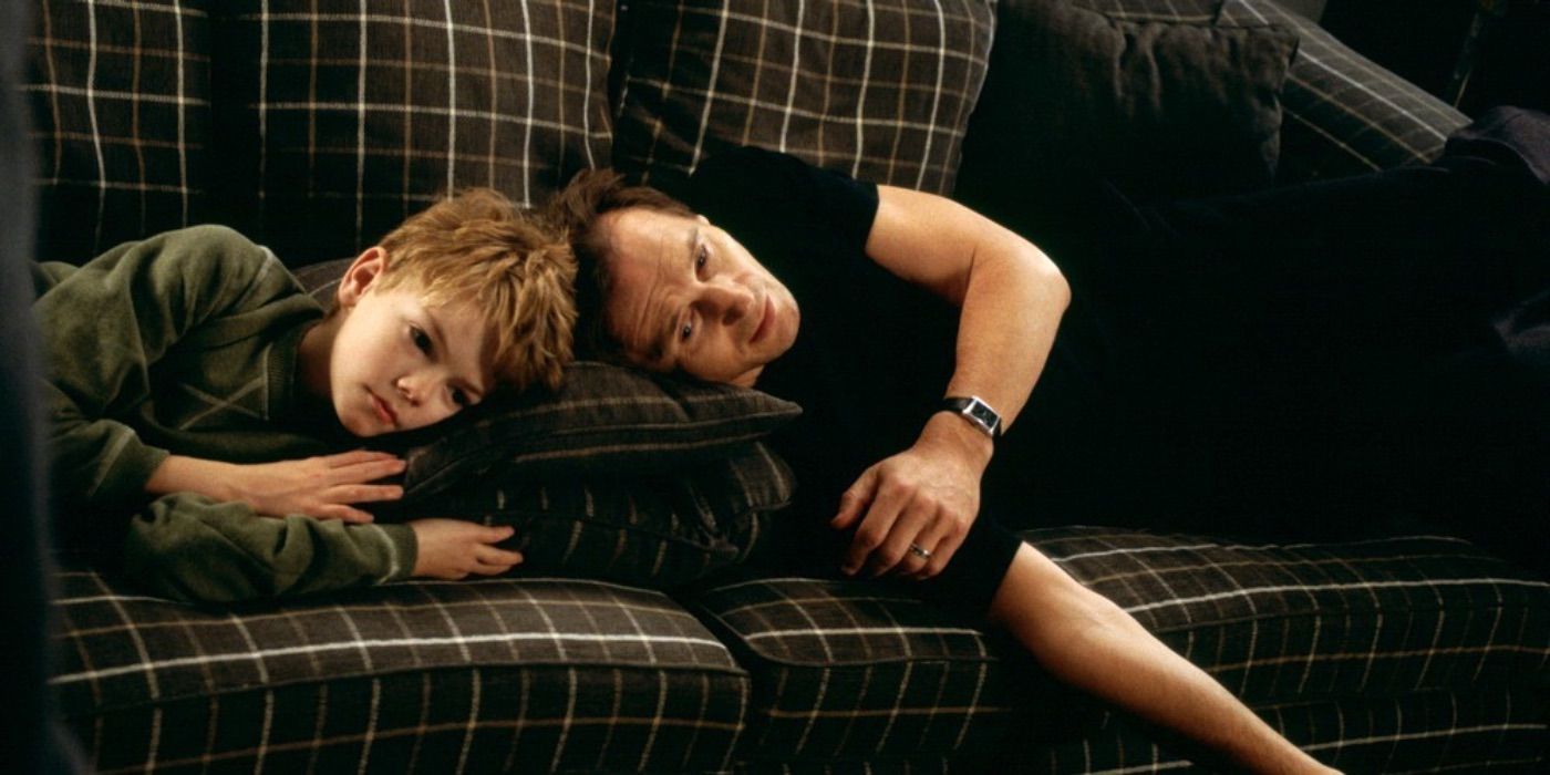 Sam and Daniel lying on their couch in Love Actually