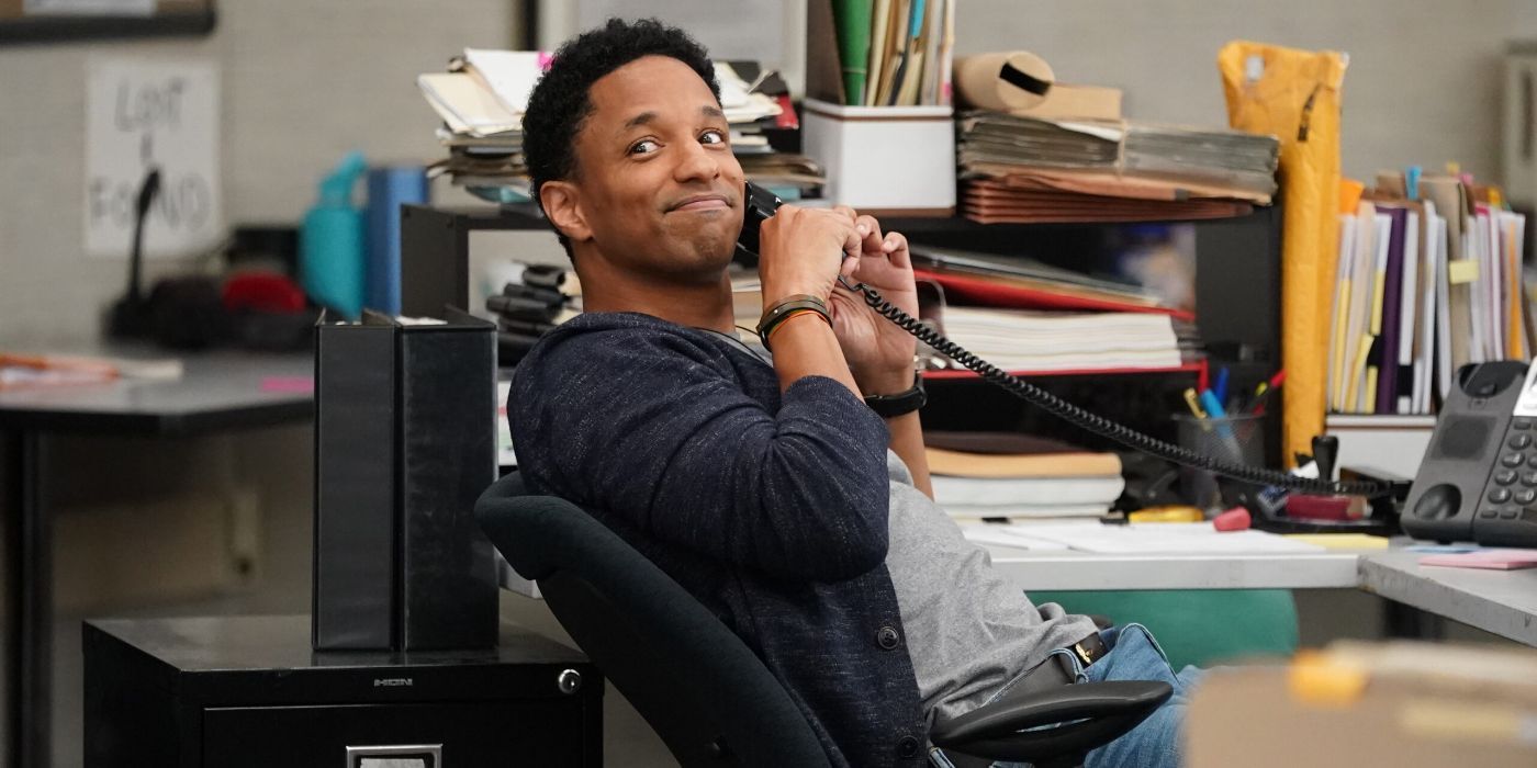 Craig Frank as Austin Teague on the phone but leaning back in his chair and smiling back at someone in Alaska Daily