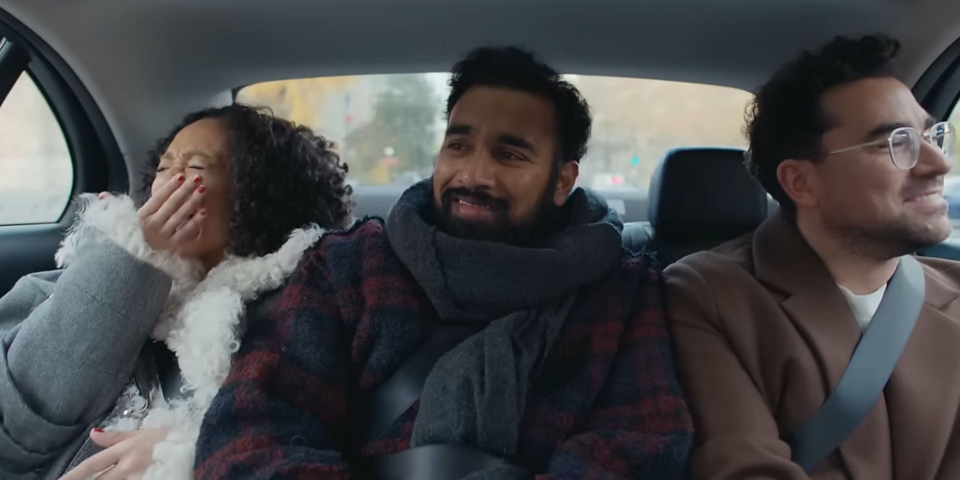 Dan Levy, Himesh Patel, and Ruth Negga in the back of a car in Good Grief