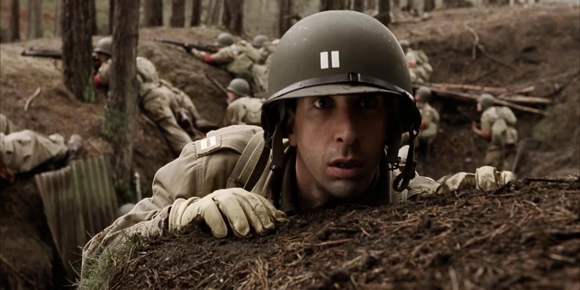 Captain Sobel (David Schwimmer) hiding during battle in Band of Brothers.