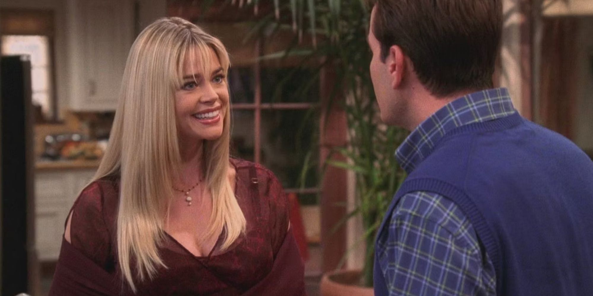 Denise Richards smiling while speaking with Charlie Sheen in the Two and a Half Men episode Merry Thanksgiving