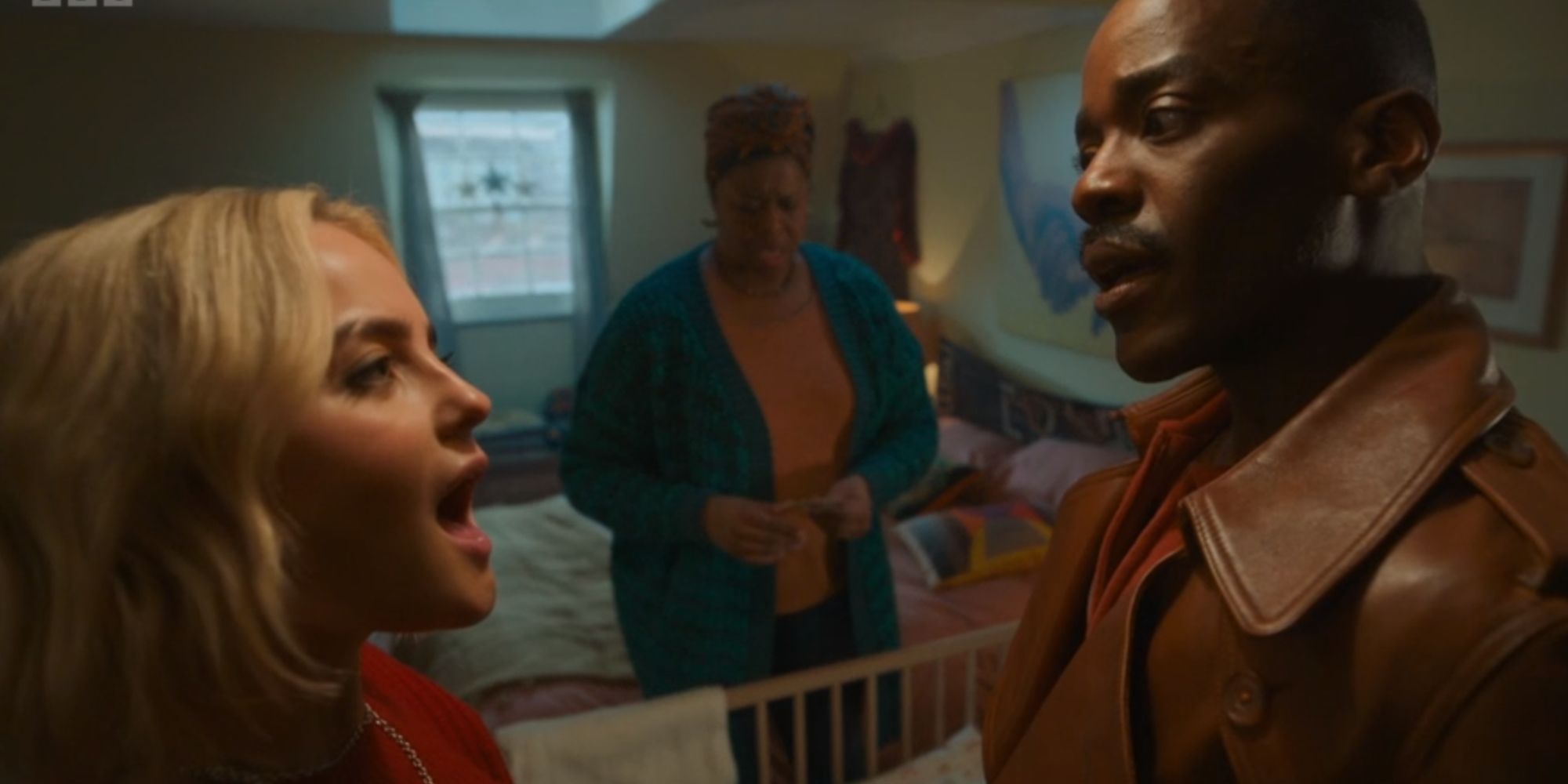 Millie Gibson and Ncuti Gatwa talking in Ruby's house with Michelle Greenidge in the background in the Doctor Who seasonal special