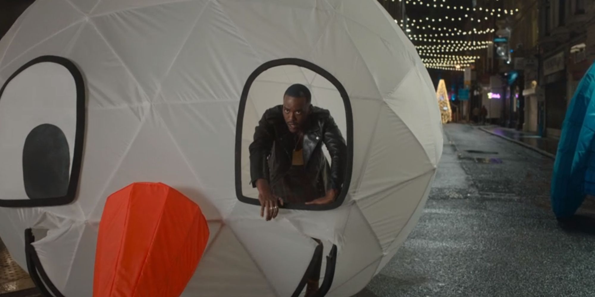 Ncuti Gatwa as the Fifteenth Doctor, climbing out of a snowman head in the episode The Church on Ruby Road