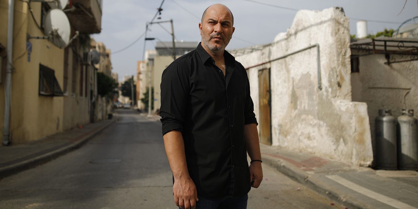 Doron (Lior Raz) standing in the middle of a street in Fauda.