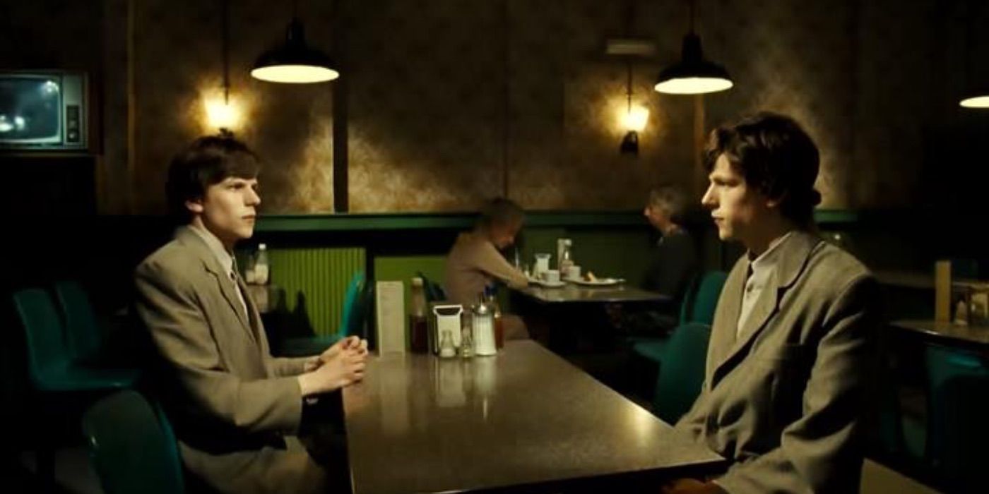 Jesse Eisenberg sits across a table from his double in The Double.