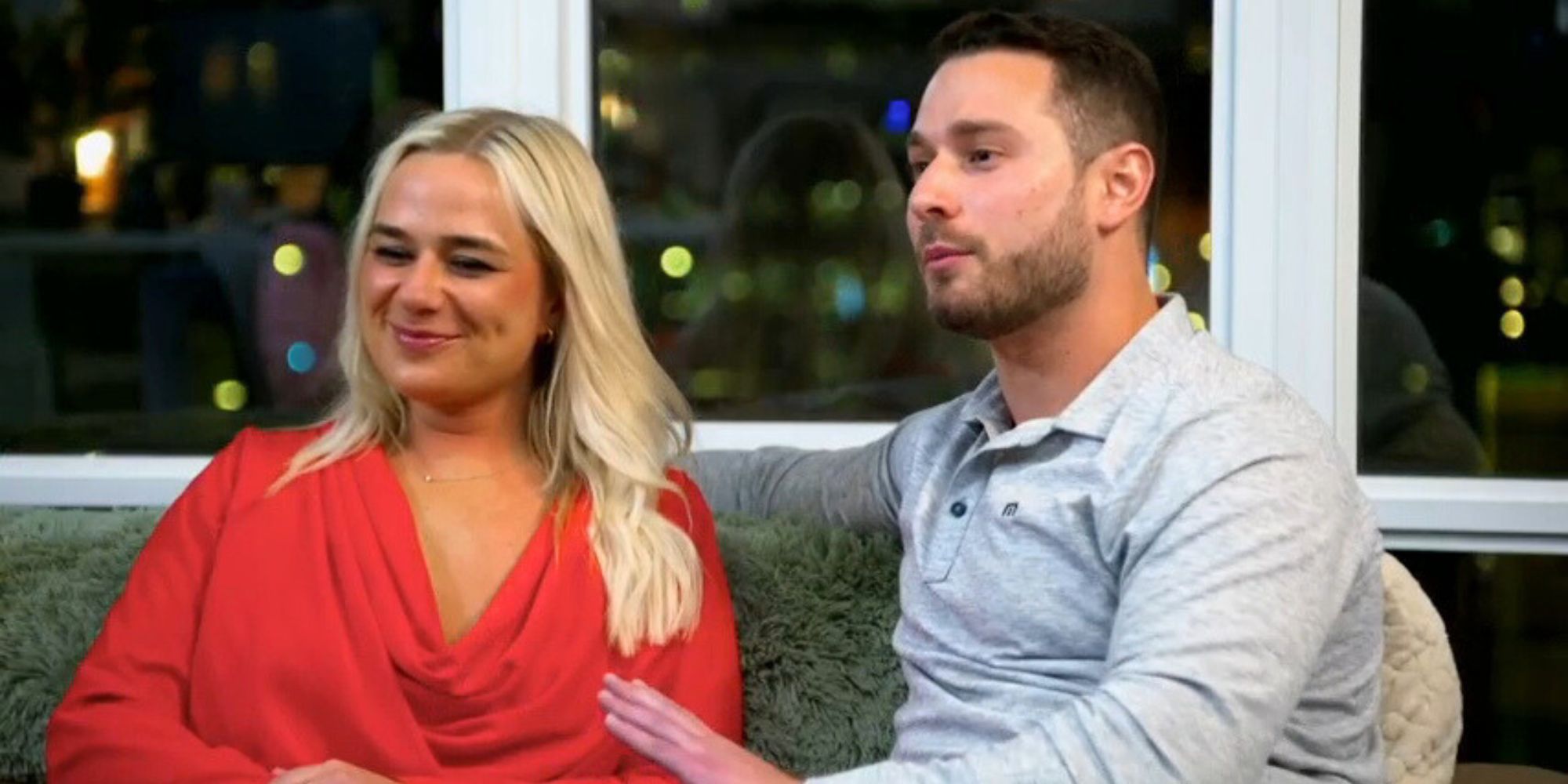 Emily and Brennan from Married at First Sight season 17 side by side on coach while having tense conversation