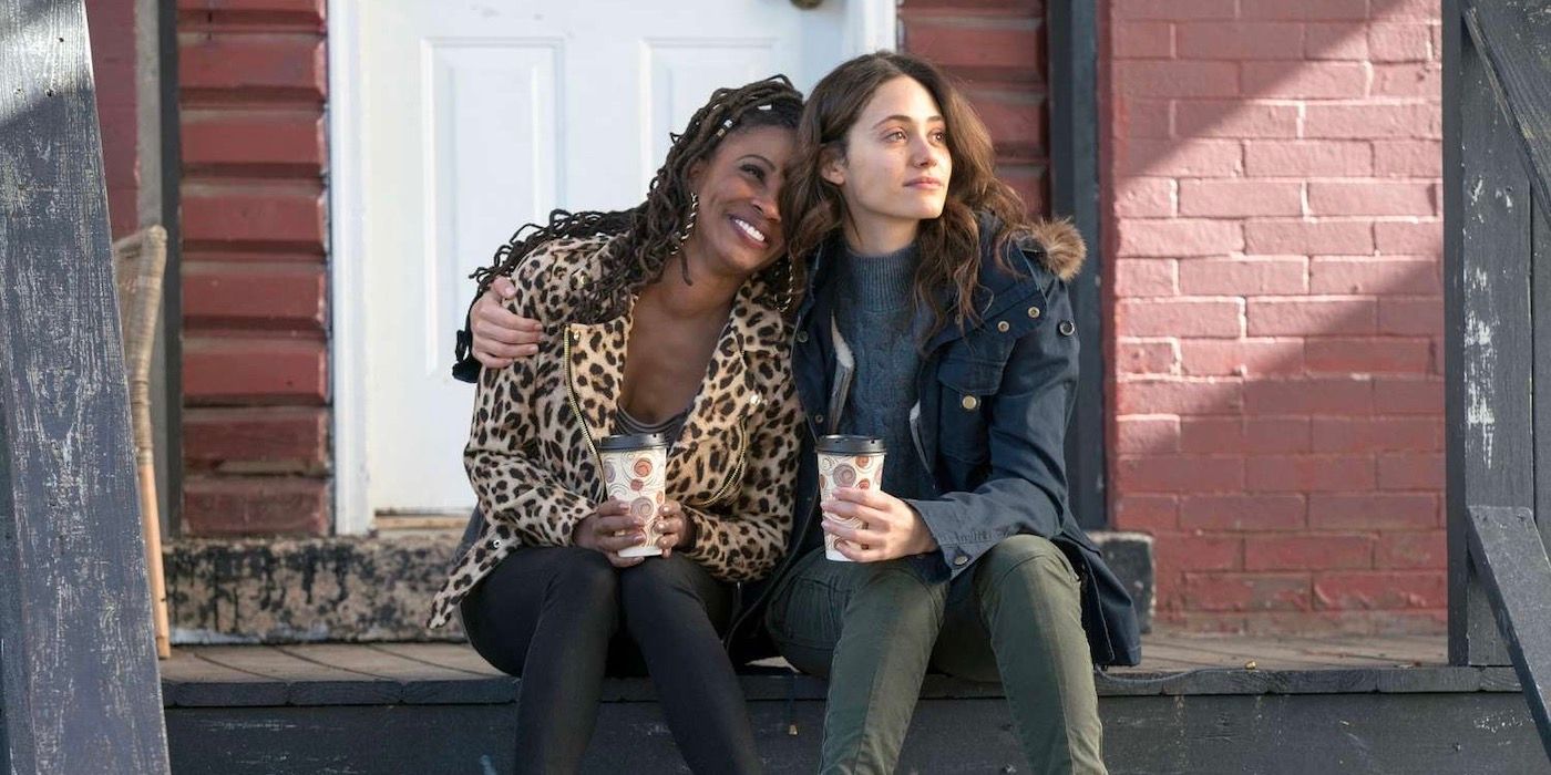 Fiona (Emmy Rossum) and V (Shanola Hampton) drinking coffee and hugging in Shameless.