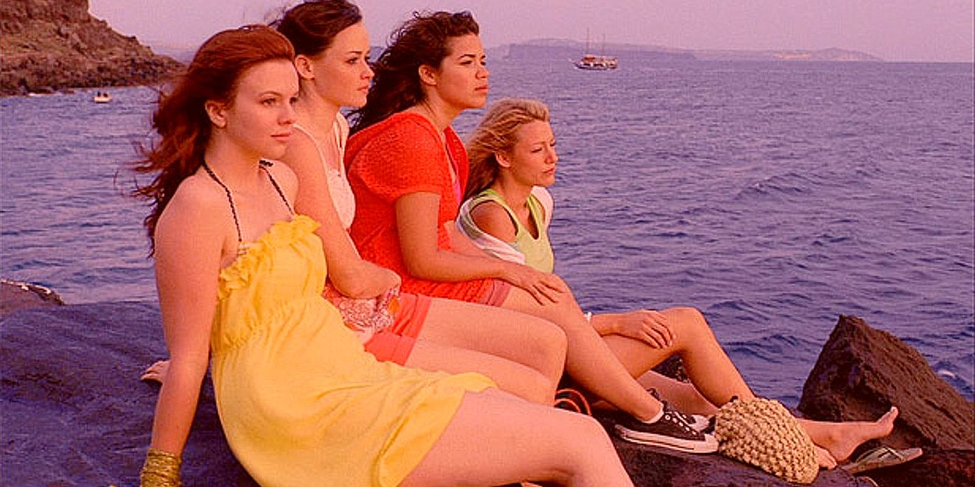 Amber Tamblyn as Tibby, Alexis Bledel as Lena, America Ferrera as Carmen, and Blake Lively as Bridget sitting on a rock and looking out into the ocean in The Sisterhood of the Traveling Pants 2.