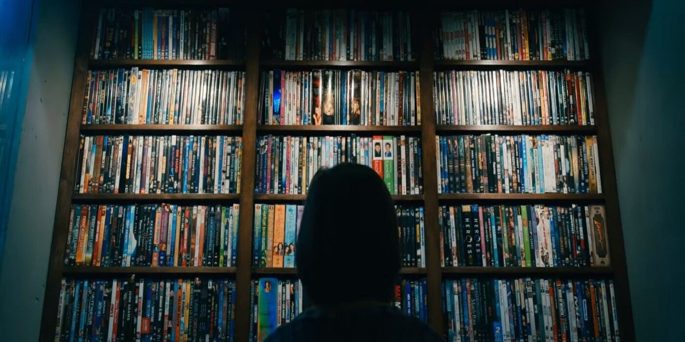 Farrah Mackenzie as Rose Sandford gazing at a massive DVD collection the doomsday bunker in Leave the World Behind