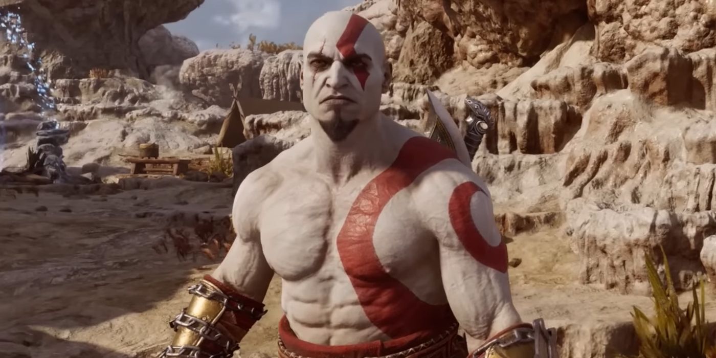 A close-up on Kratos in God of War Ragnarok, with his classic appearance turned on. He has a goatee rather than a full beard, his ash-stained skin is a brighter white, and his tattoos are a more vibrant red.