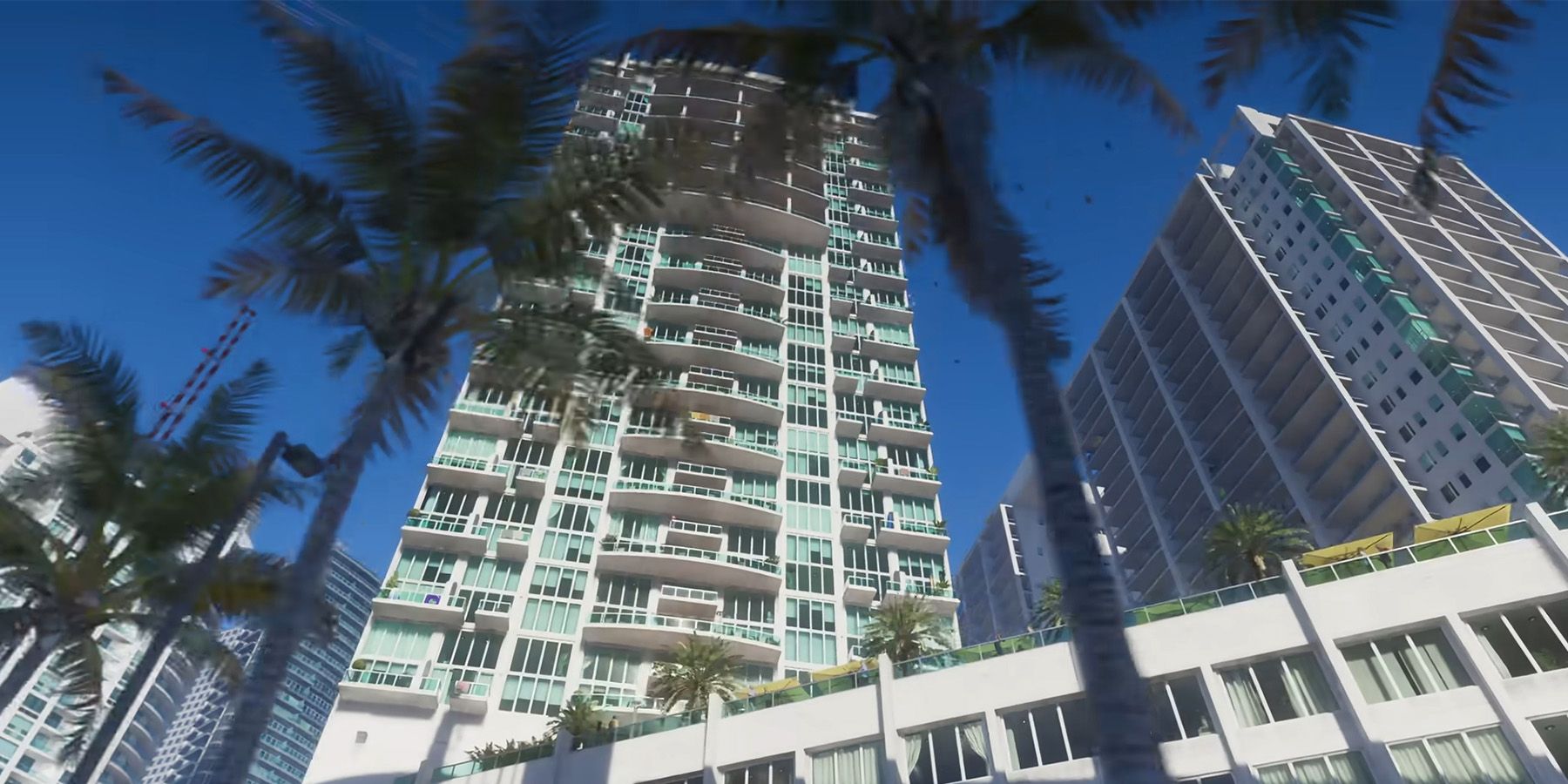 Tall hotel buildings behind palm trees in GTA 6.