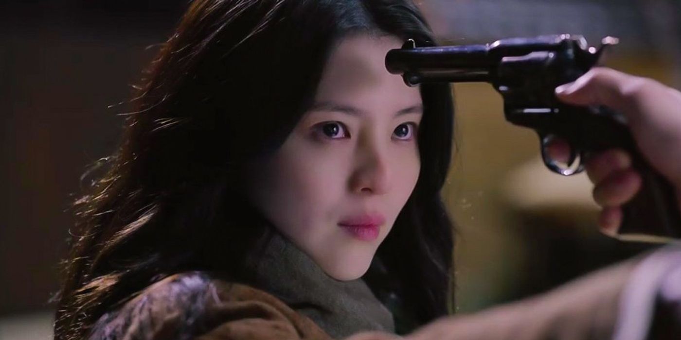 Han So-hee as Yoon Chae-ok with a gun pointed to her head in Gyeongseong Creature