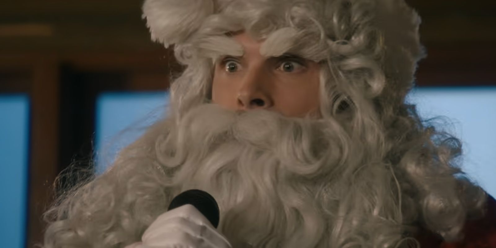 Carter holds a microphone while dressed as Santa in Holiday in the Vineyards.