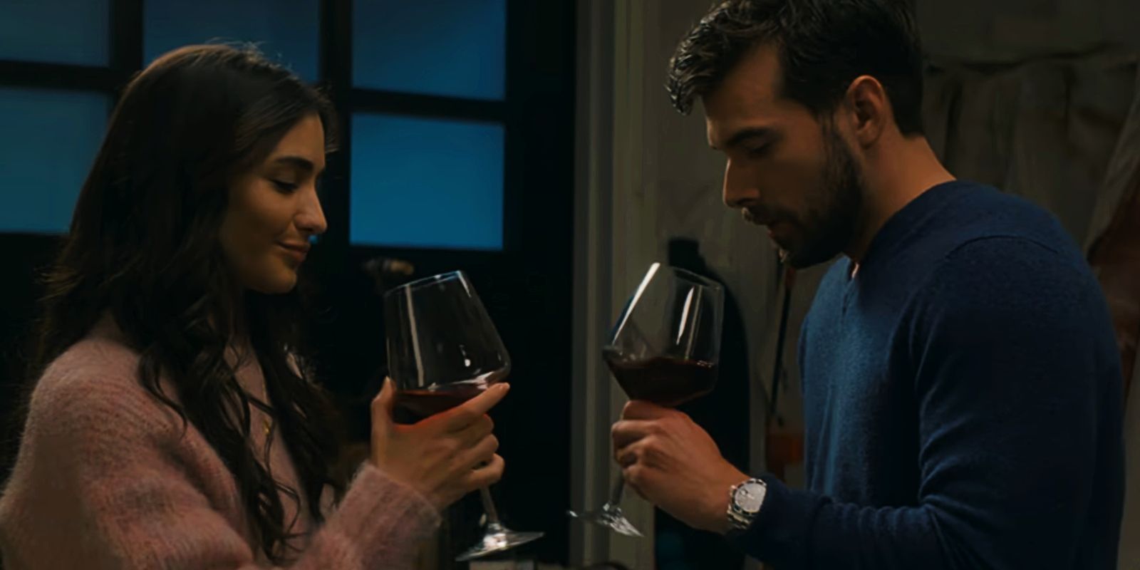 Valentina and Carter look down at their wine glasses in Holiday in the Vineyards.