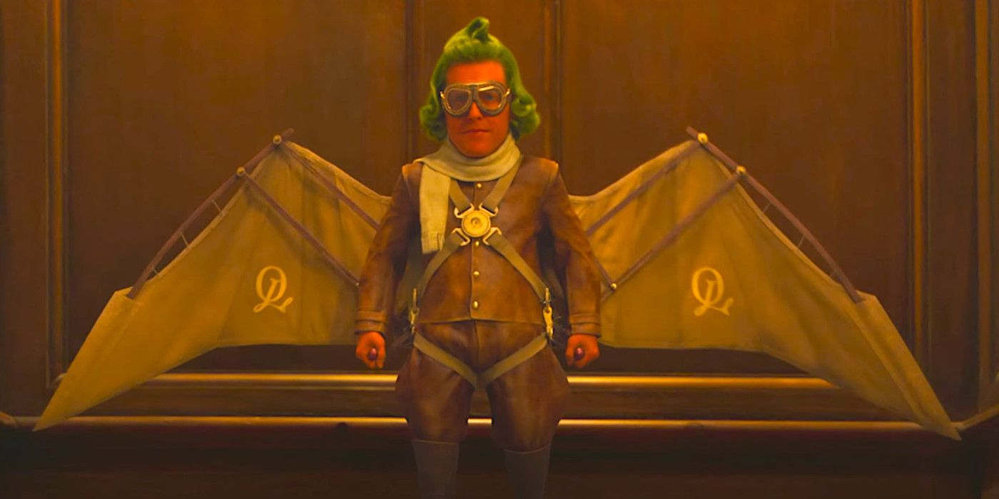 Hugh Grant as Oompa Loompa Lofty wearing home made wings in a funny scene from Wonka