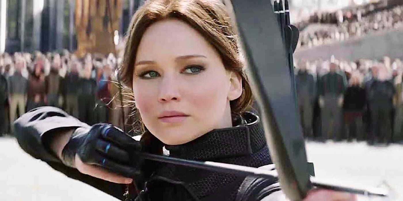 Jennifer Lawrence as Katniss Everdeen aims a bow and arrow in The Hunger Games: Mockingjay - Part 2
