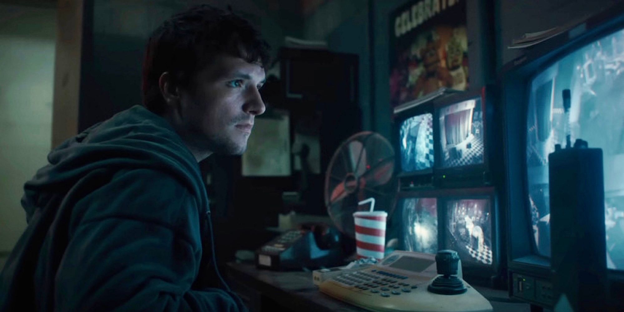 Mike (Josh Hutcherson) is looking at the monitors in Five Nights at Freddy's.