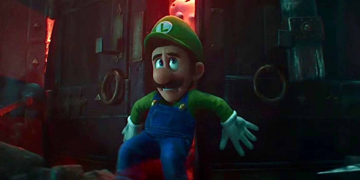 Charlie Day as Luigi holds back a door in The Super Mario Bros. Movie.
