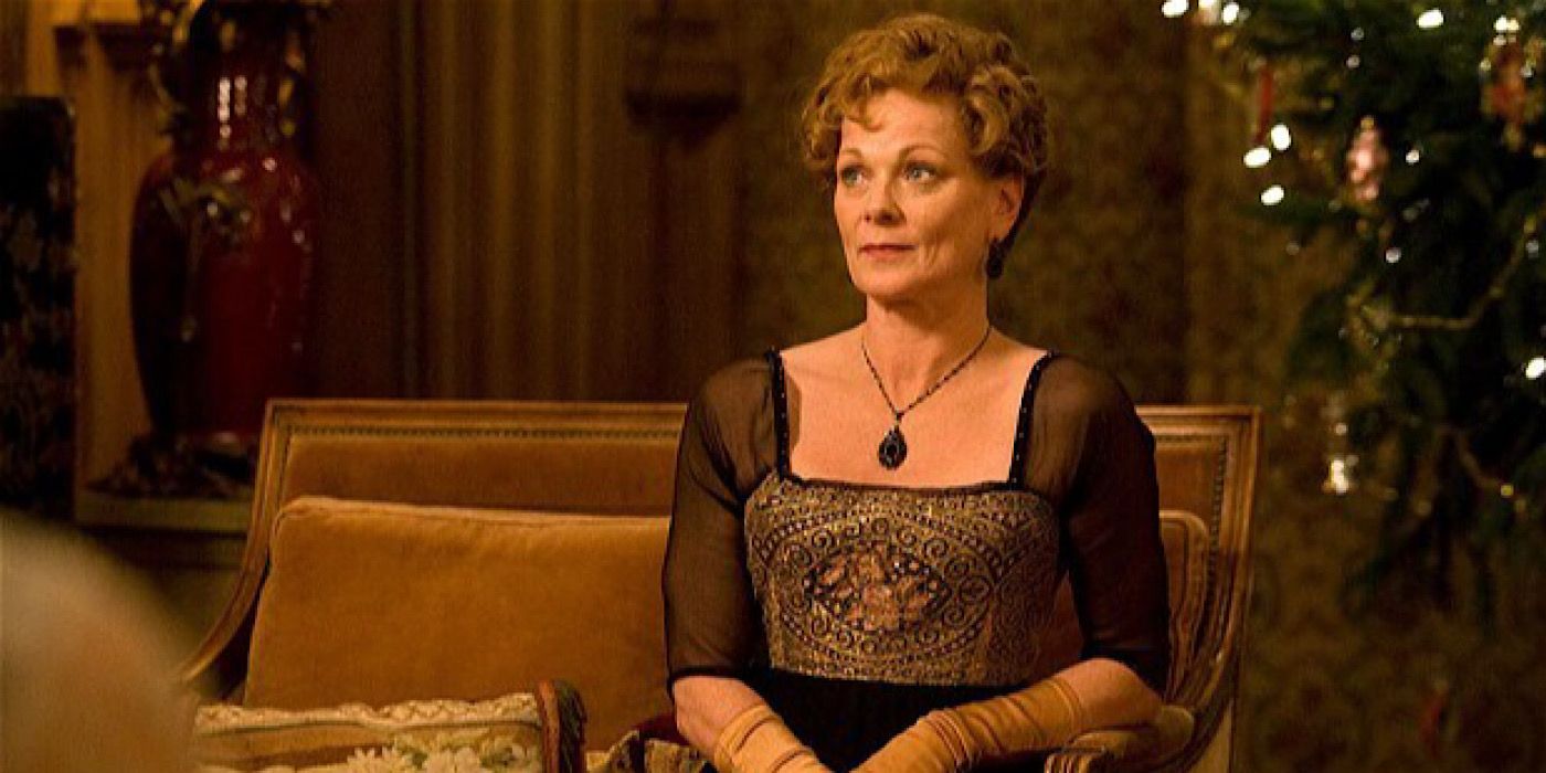 Rosamund Painswick sitting on a couch in Downton Abbey.