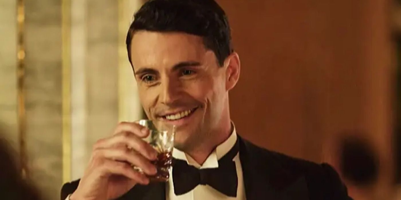 Henry Talbot is holding a glass of alcohol on Downton Abbey.