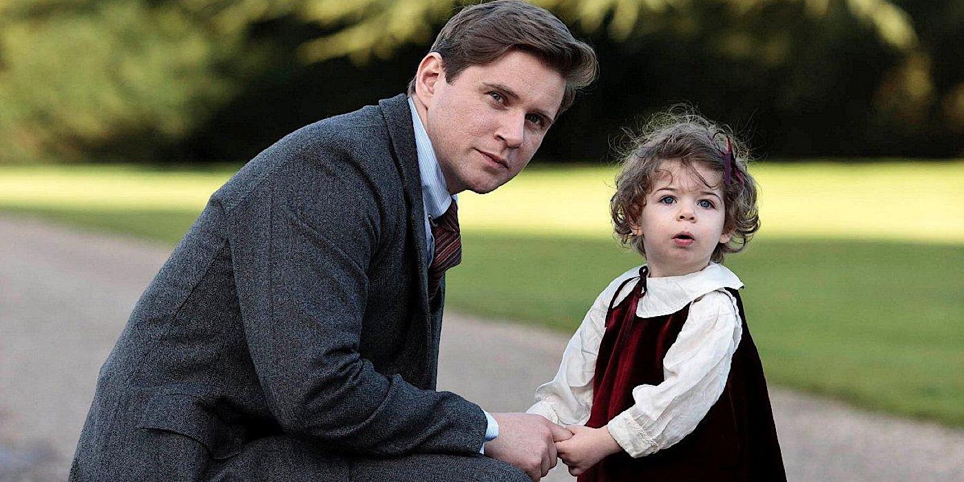 Tom holding his daughter Sybbie's hands on Downton Abbey.