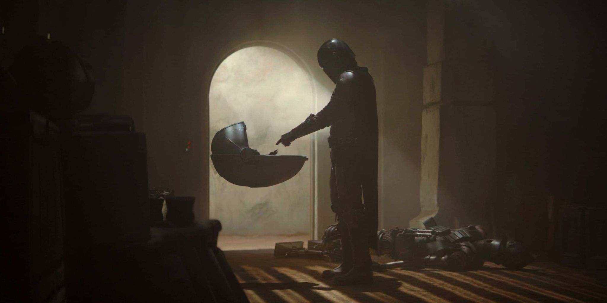 Din Djarin estende o dedo para Grogu no episódio 1 da 1ª temporada de The Mandalorian