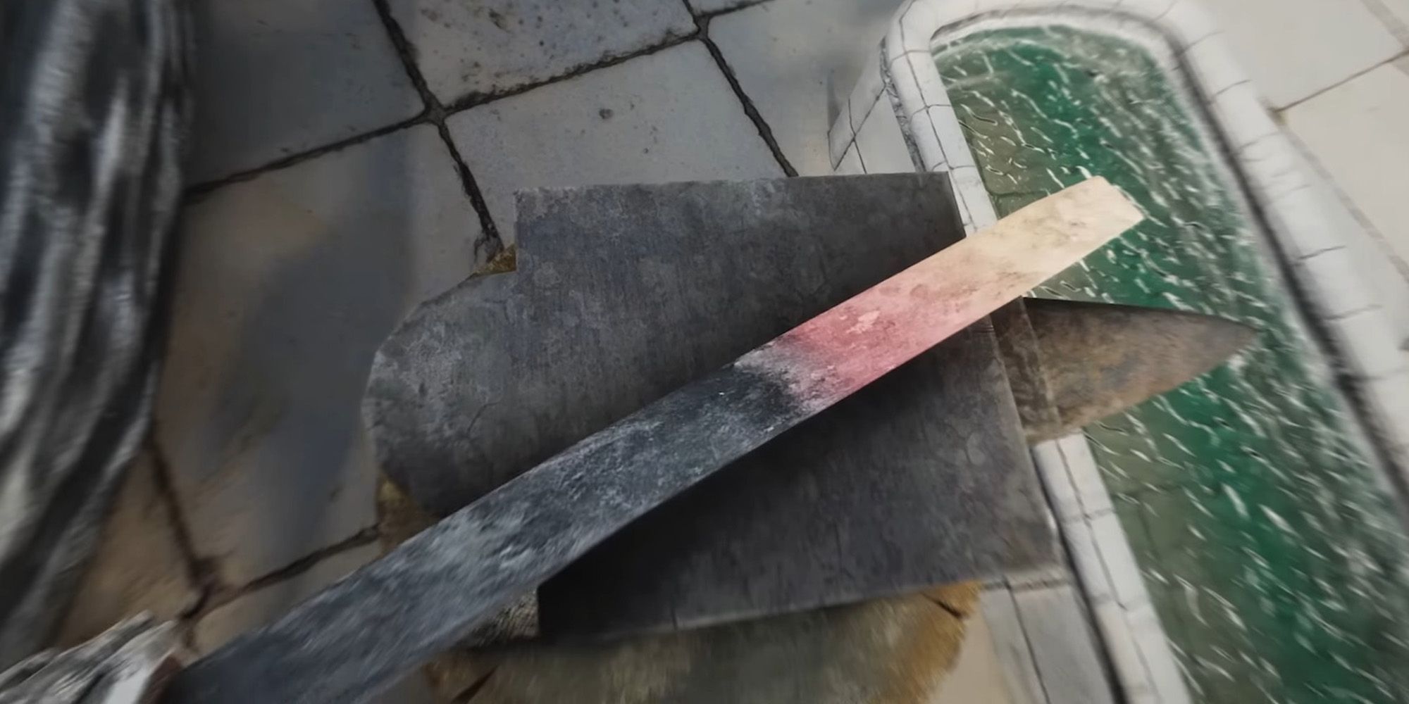 Improved Camera SE Skyrim Mod showing a first-person view of using an anvil to forge a weapon.