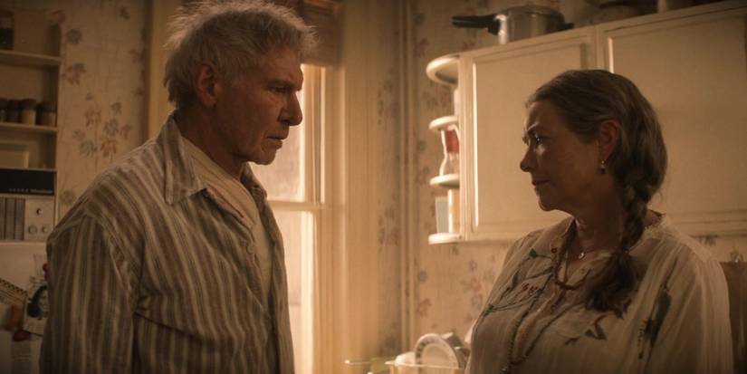 Indiana Jones (Harrison Ford) and Marion (Karen Allen) looking at each other in an apartment in Indiana Jones and the Dial of Destiny,