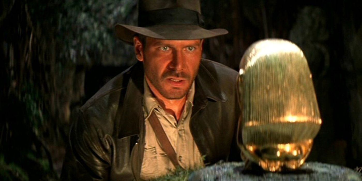 Indiana Jones (Harrison Ford) looking at the artifact in Raiders of the Lost Ark