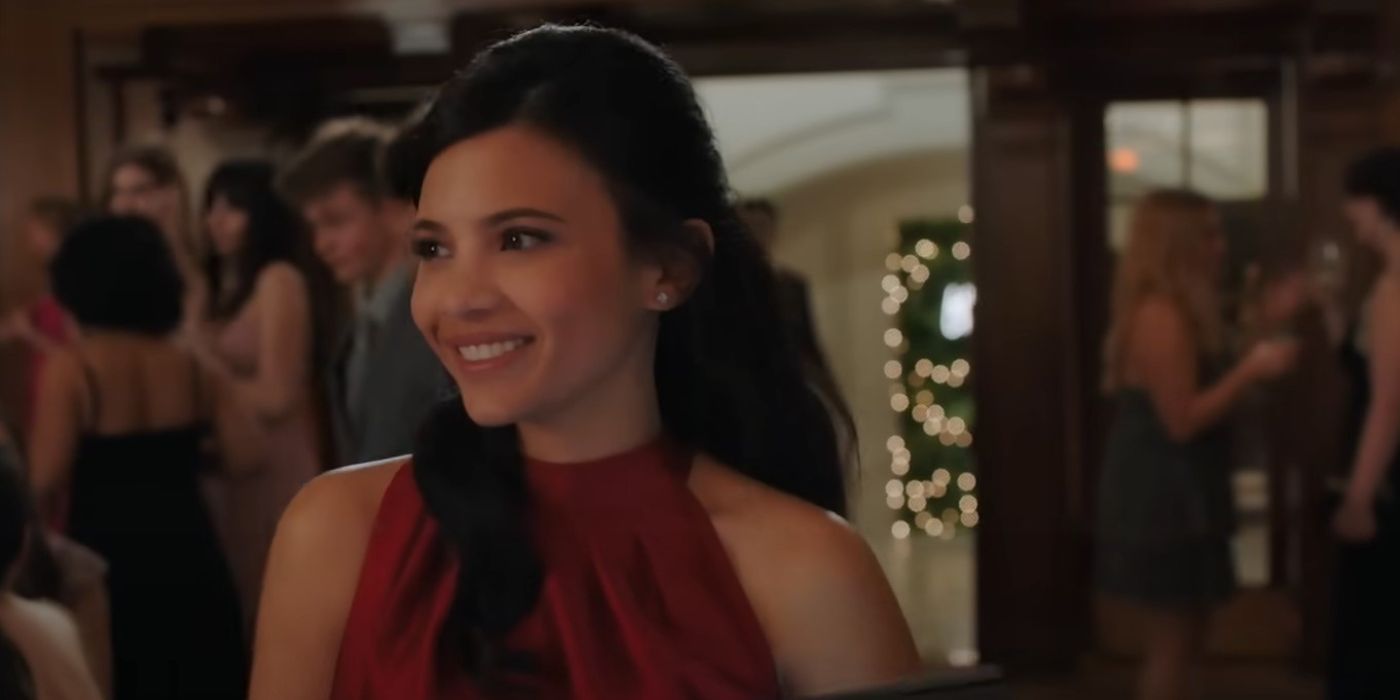 Nikki Rodriguez as Jackie wearing a red dress, smiling in New York in the first episode in my Life with the Walter Boys
