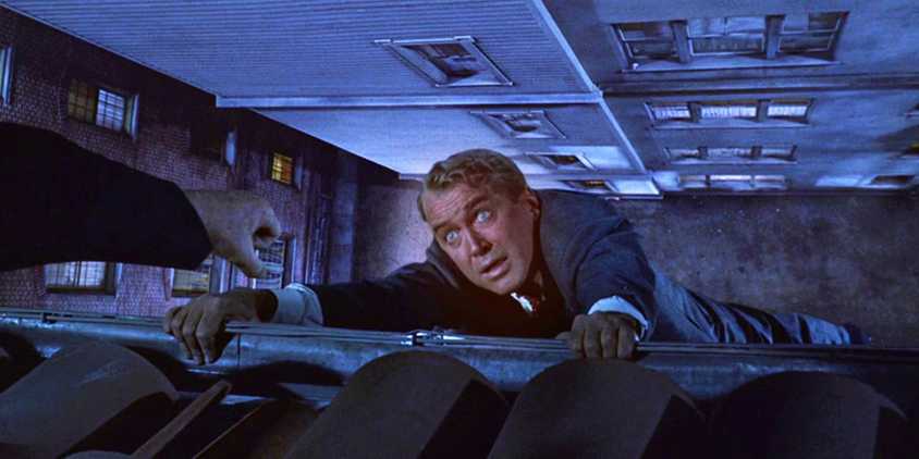 James Stewart as John Scottie Ferguson dangling from a building in Vertigo
